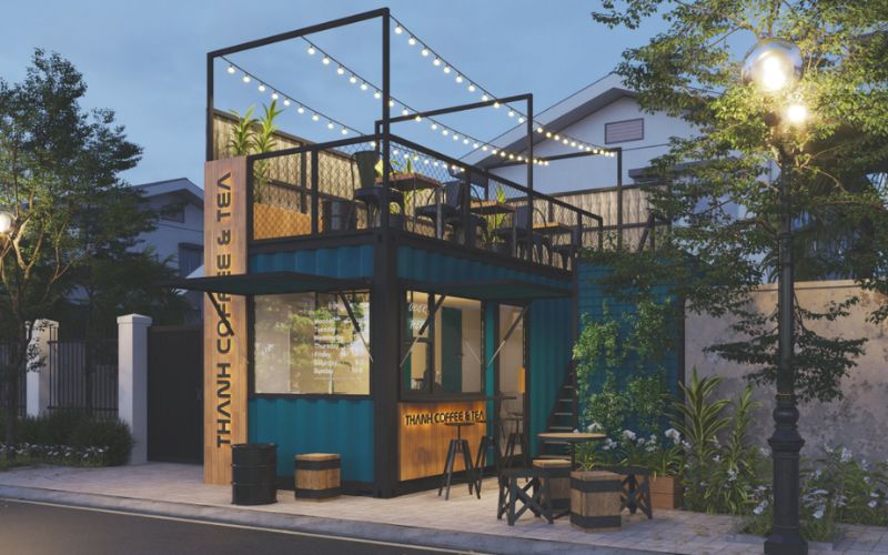 Quán trà sữa container dạng xếp tầng màu xanh rêu, nhấn điểm đèn trang trí